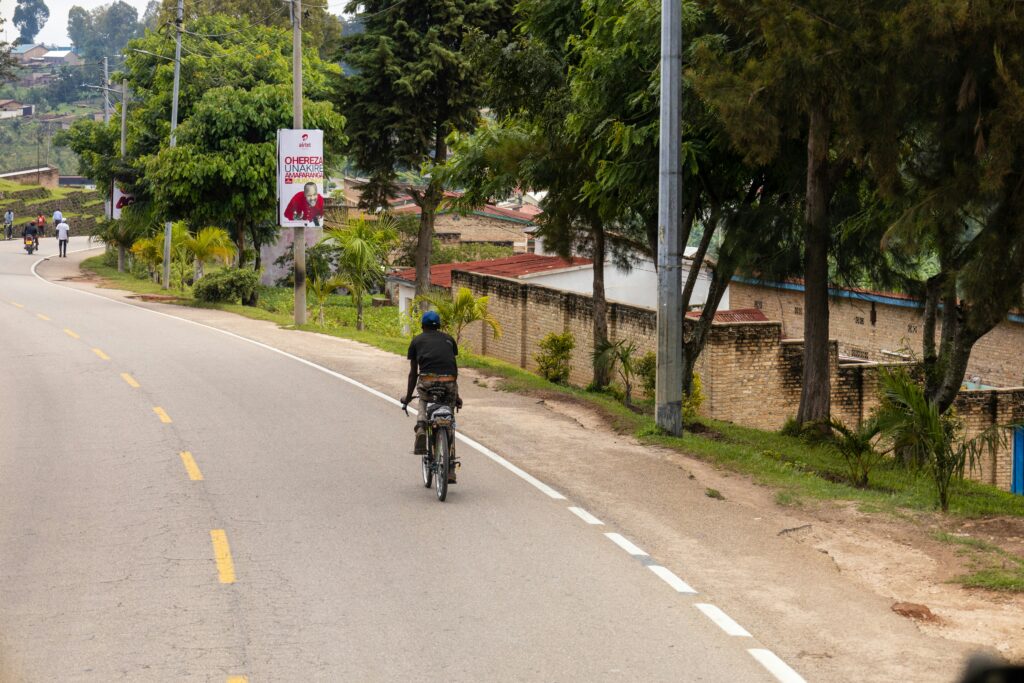 man riding bicycle in african road
